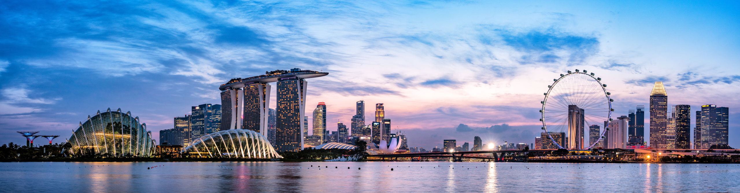 Singapore's skyline at dusk with a pink and blue sky 