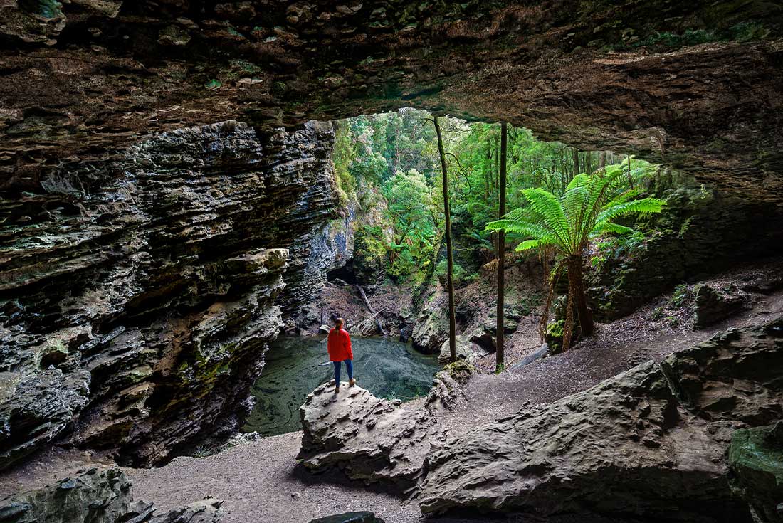 PUKT - Traveller looking through Trowutta Arch, Tasmania 