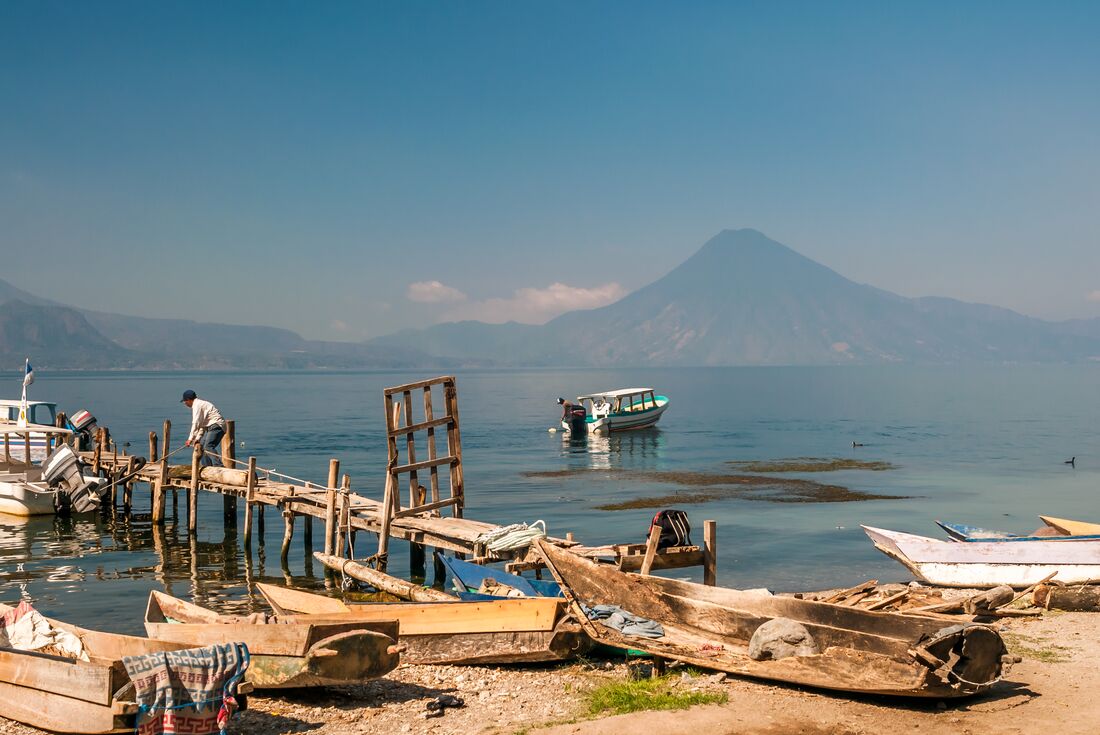 A view of boats and a volcano at Lake Atitlan, Guatemala