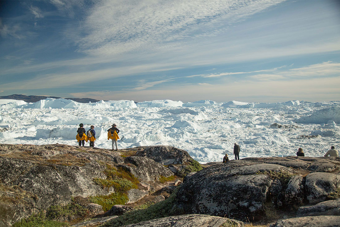 Travellers look out on the ice sheets in Ilulissat