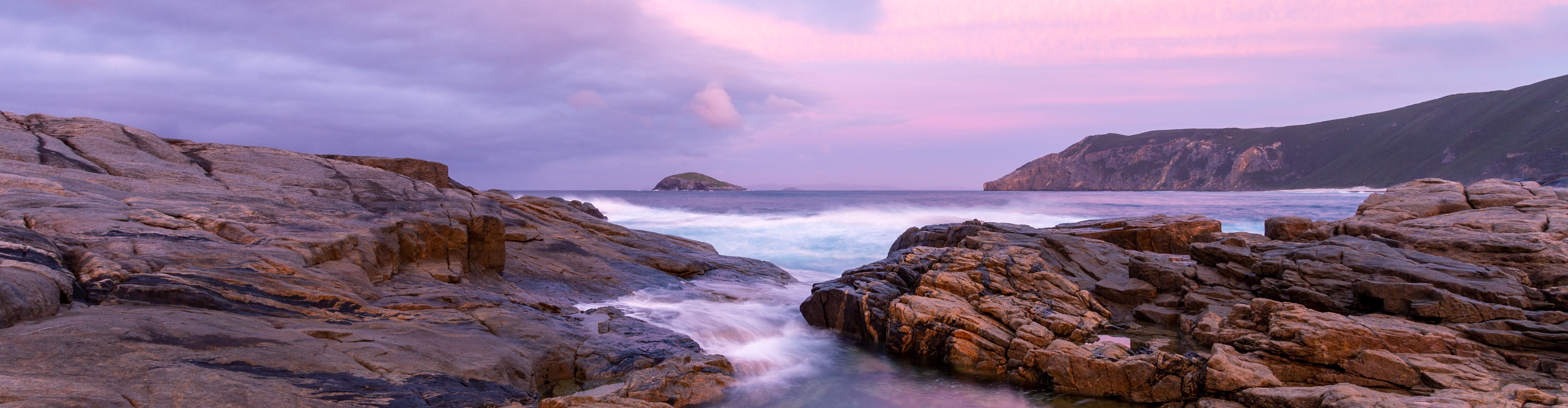 Sunrise at the Gap, with pink fluffy clouds and blue water, Albany, Western Australia 