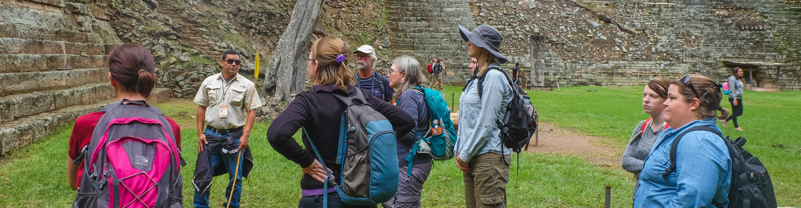 Group with a guide looking at an ancient temple in Honduras 