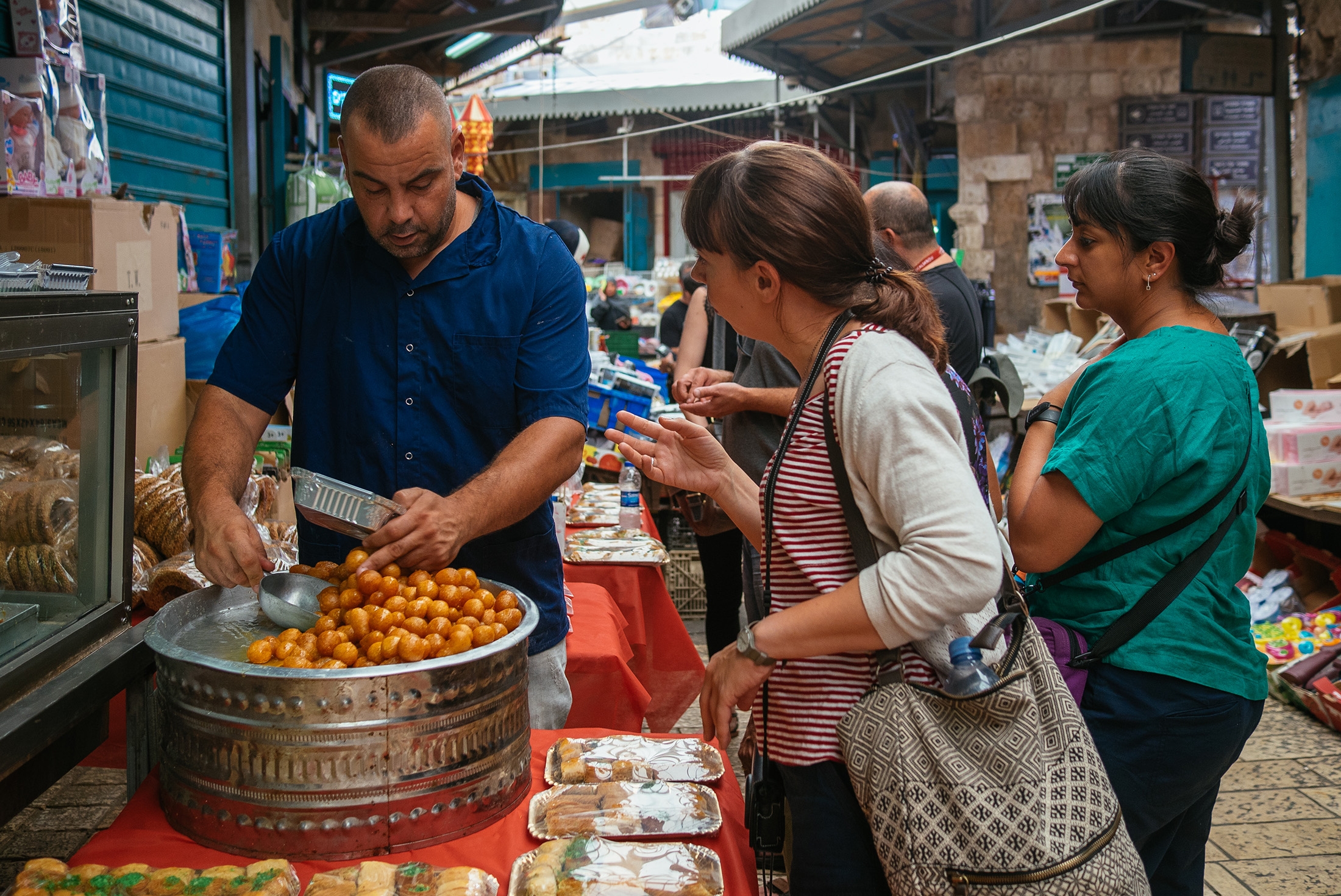 Travellers buying traditional snacks at a local market