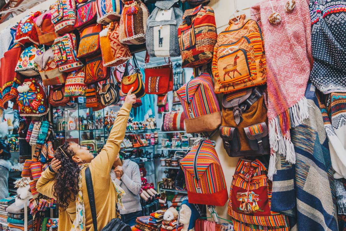 Intrepid traveller shopping in the markets of Cusco in Peru