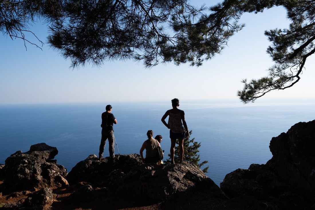 Intrepid travellers look out over the Aegean sea at the end of the Agia Irini Gorge hike on Crete