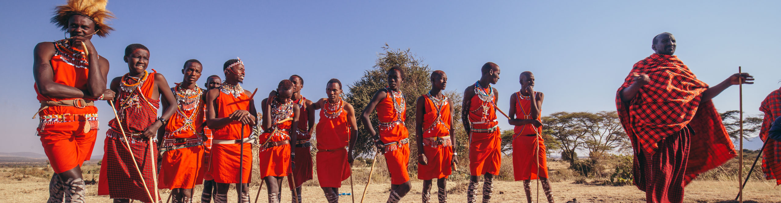 Maasai worries standing in their traditional dress in the sunshine in Kenya