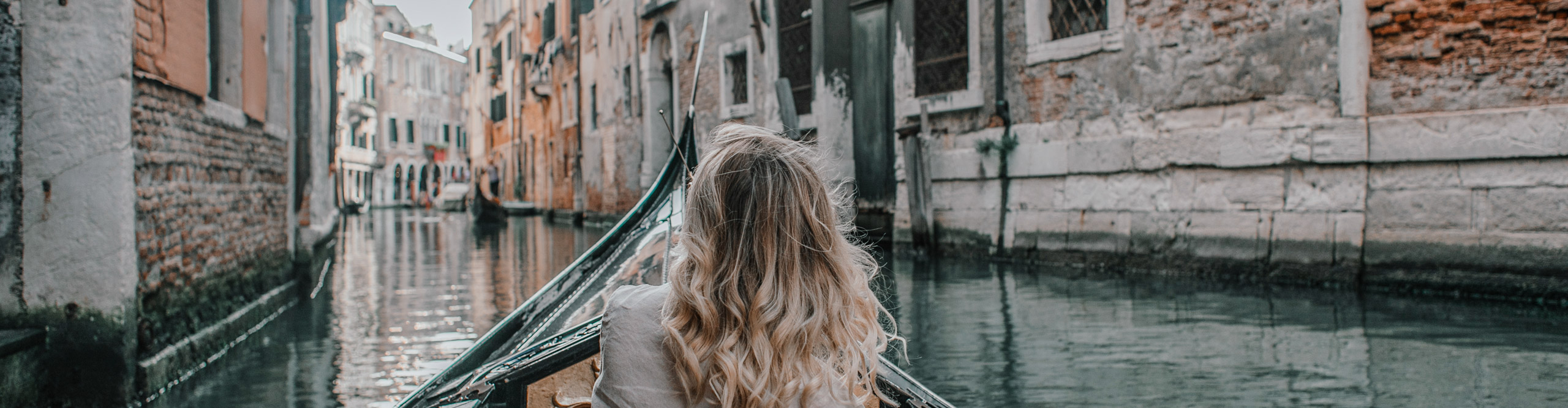 Traveller on Gondola in the Canals of Venice