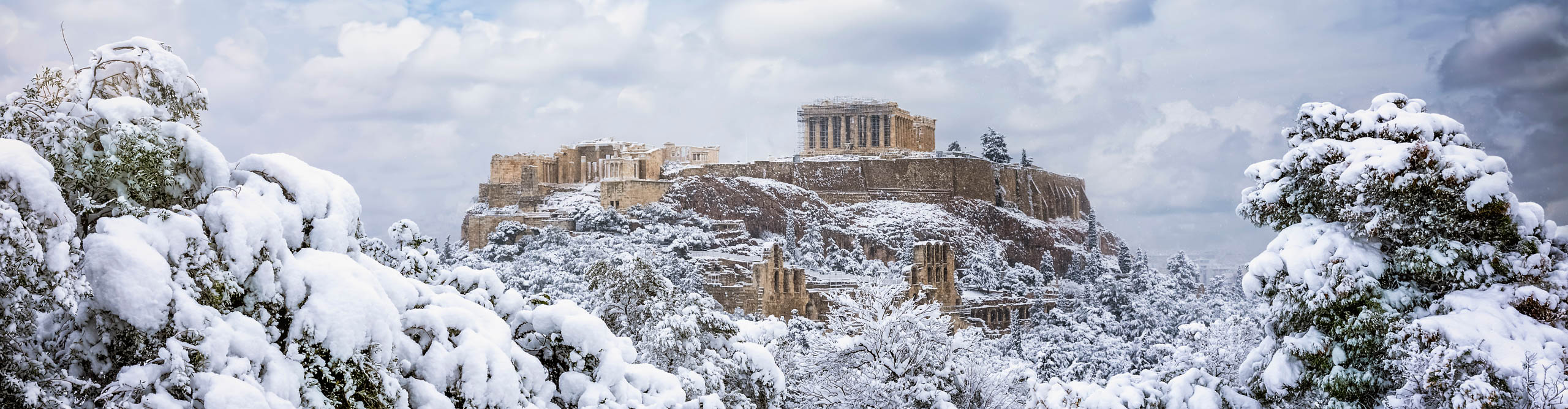 Snow on Parthenon Temple and trees in Athens, Greece