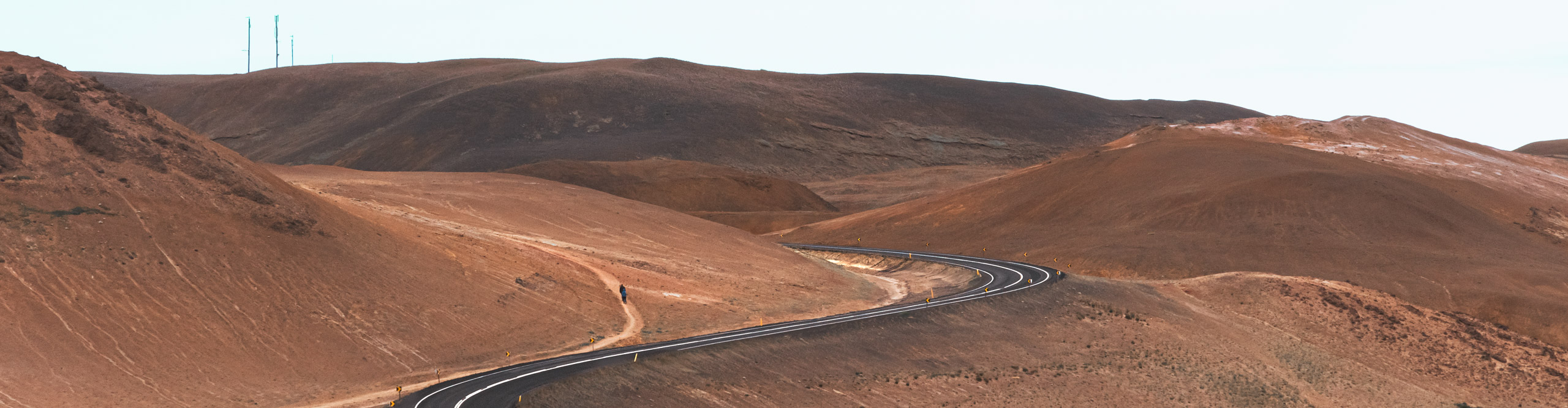 A road snaking through the beautiful brown and orange tones of the hills in Iceland 