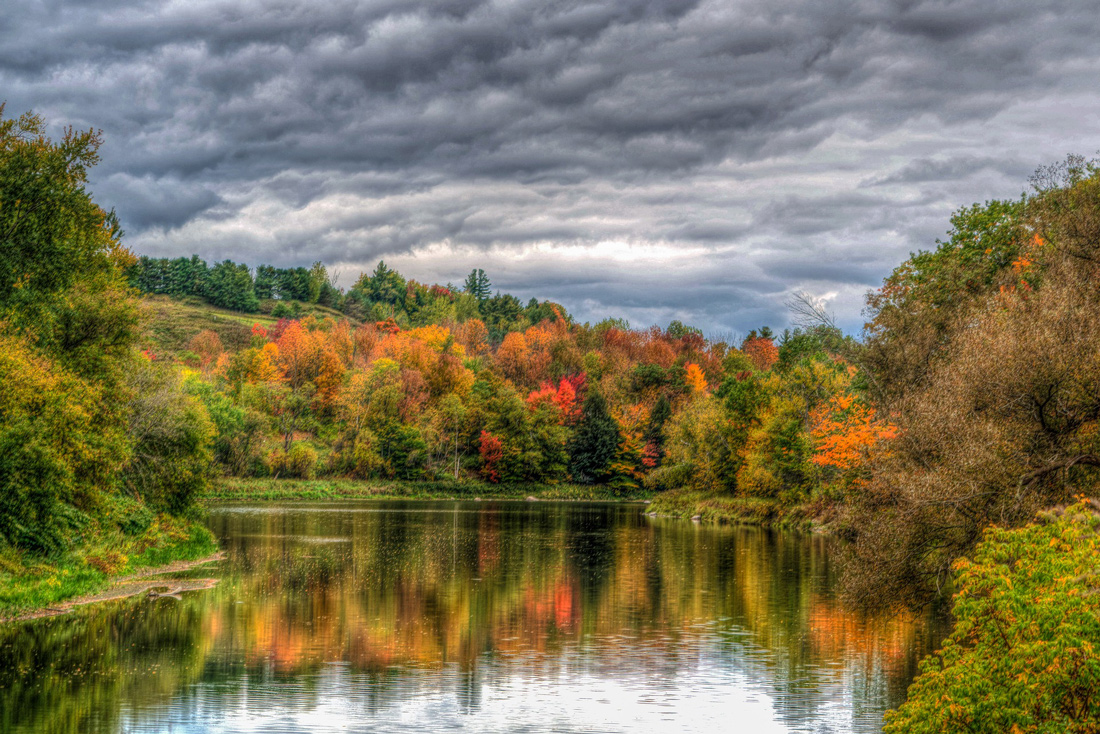 Lake surrounded by beautiful autumnal trees in Vermont, USA