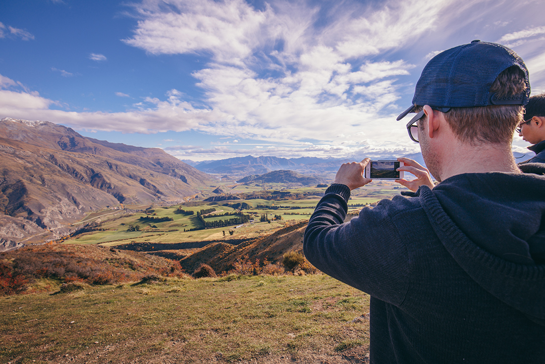 Passenger taking a photo of the beautiful scenery from Cardrona in the Otago Region of New Zealand