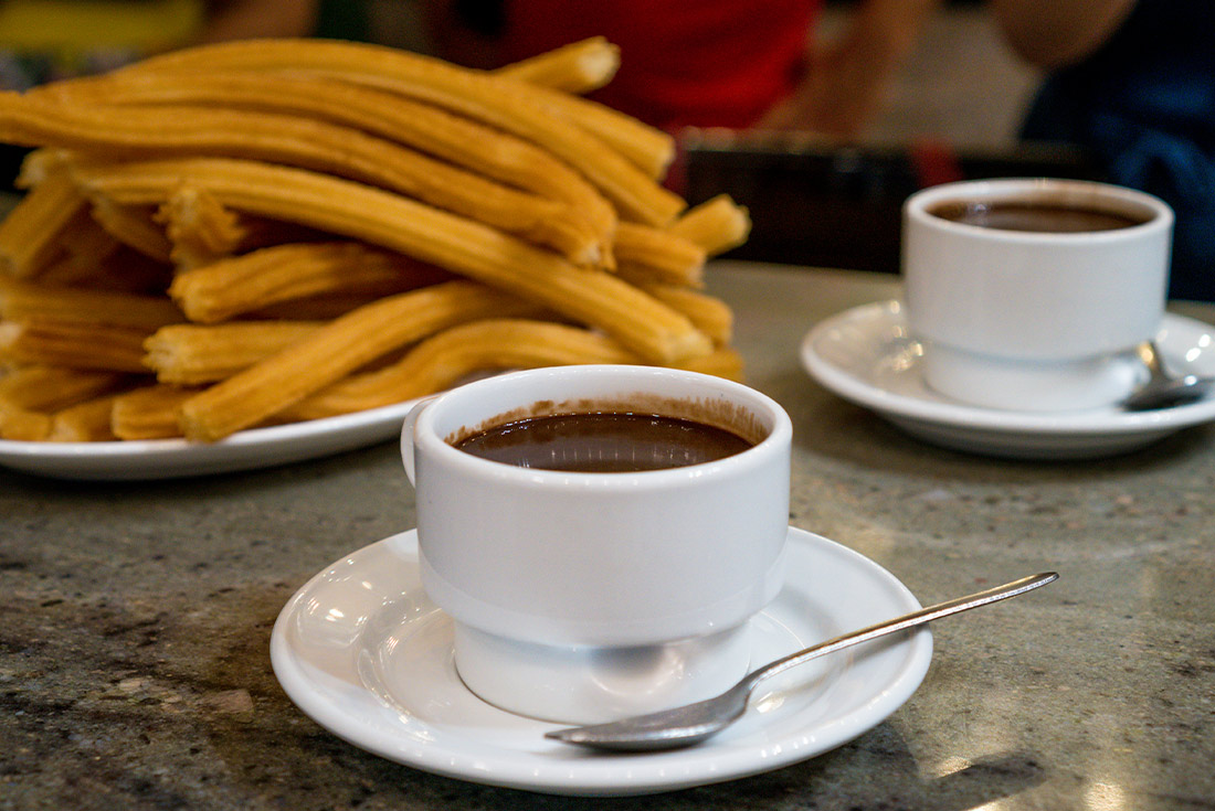 A cup of coffee and churros in Madrid, Spain