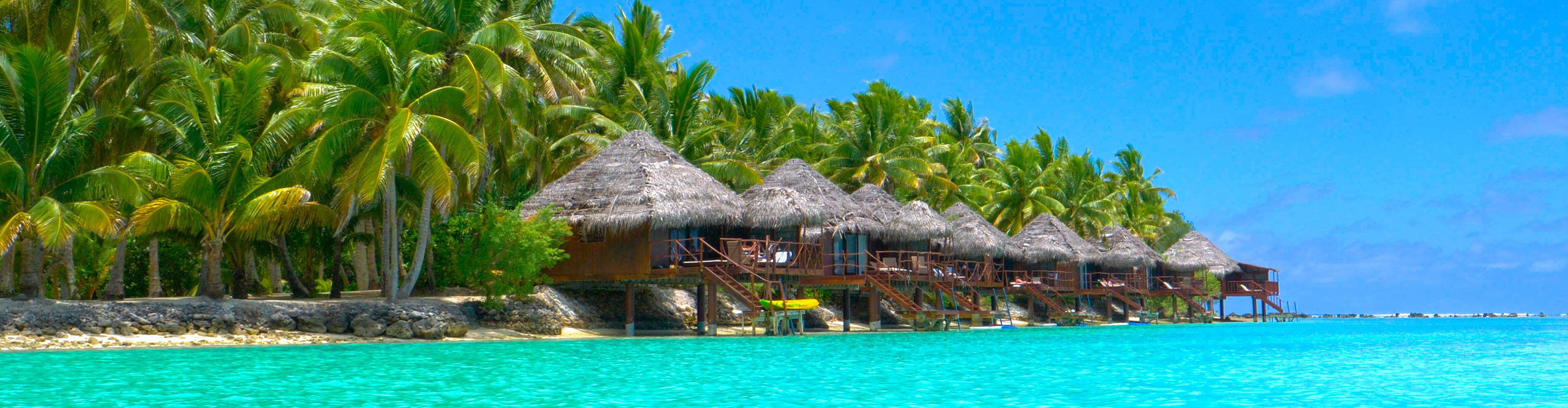 Beautiful luxury overwater villas face the stunning turquoise ocean in the idyllic Cook Islands