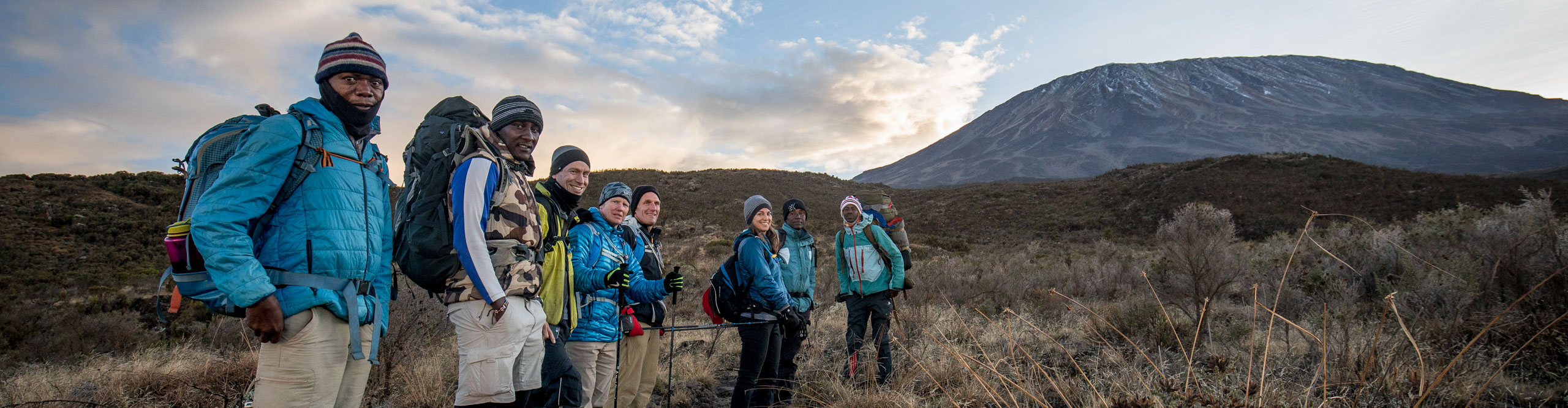 Hikers getting ready to climb Mount Kilimanjaro on a sunny day 