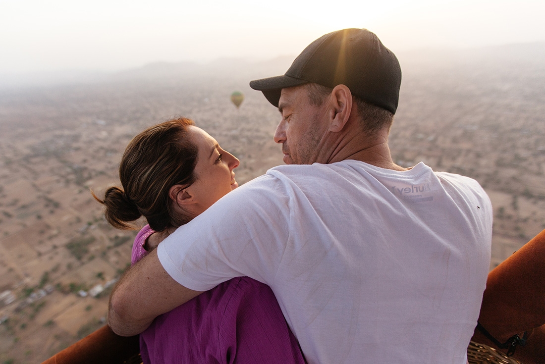 Couple hugging in a balloon ride over Jaipur in India on an Intrepid Travel tour.