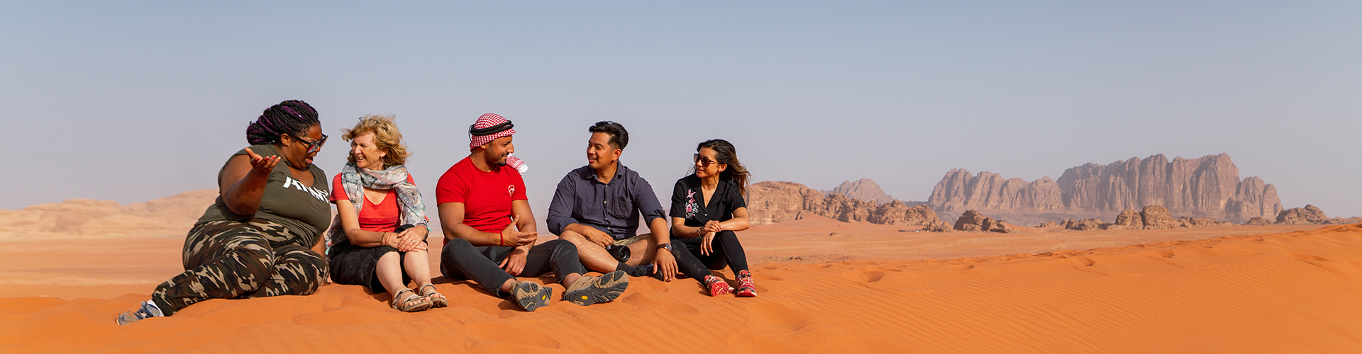 Group of travellers in Wadi Rum, Jordan with Intrepid Travel