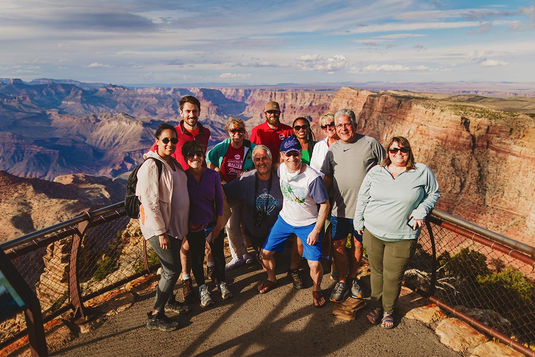 Travellers and local leader posing infant of the Grand Canyon lookout, Arizona, U.S.A.