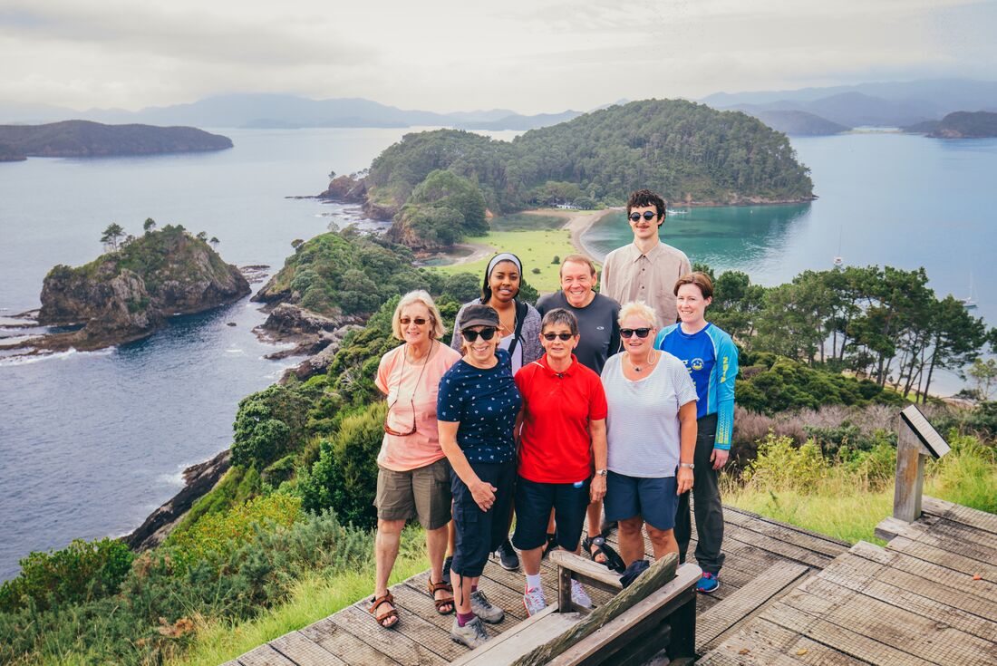 Group of Intrepid travellers at the end of a hike in the Bay of Islands on the North Island of New Zealand