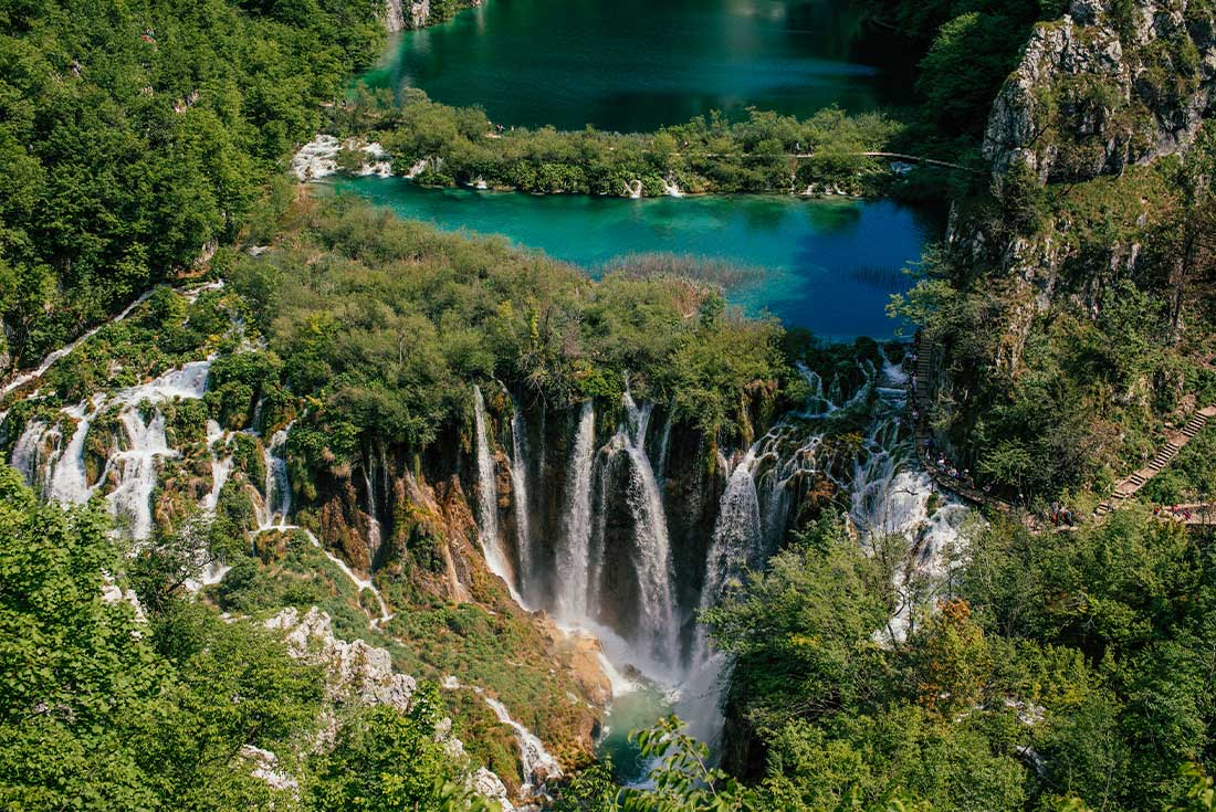 Green waterfalls amongst lush forrest of Plitvice lakes