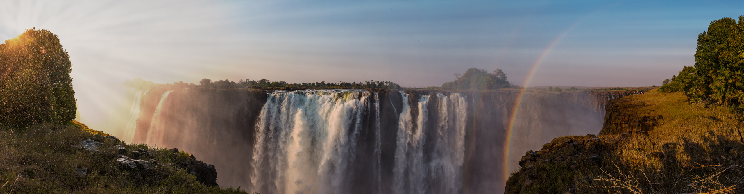 The great Victoria Falls near Livingstone in Zimbabwe, with a rainbow at dusk 