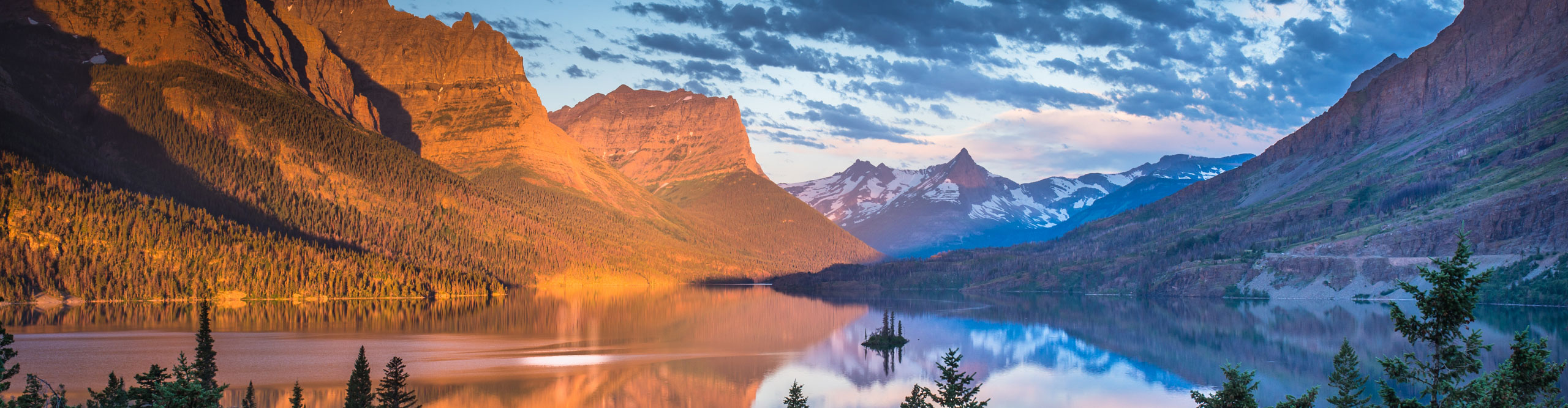 Sunrise with red mountain and a blue sky at Wild Goose Island, Glacier National Park, Montana, USA