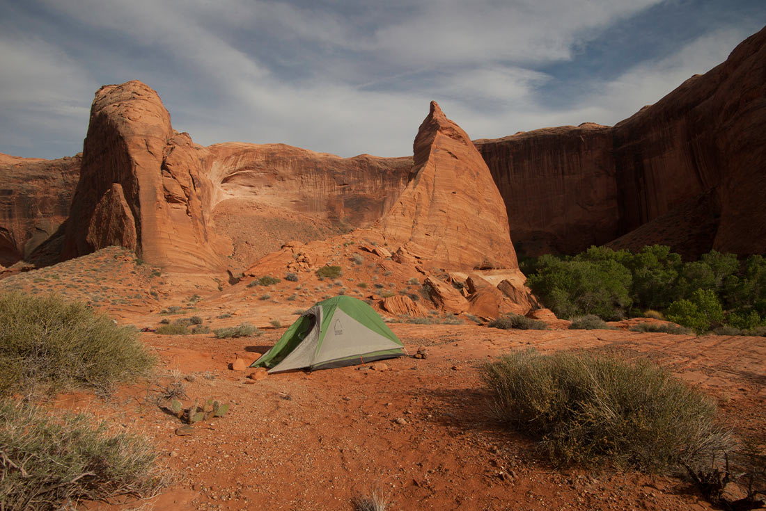Tent set up on camp ground in Coyote Gulch, Utah, U.S.A.