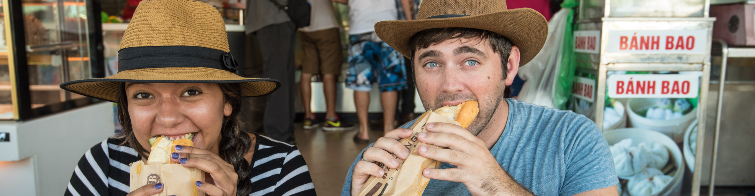 Travellers eating Bahn Mi in a cafe in Hoi An, Vietnam 