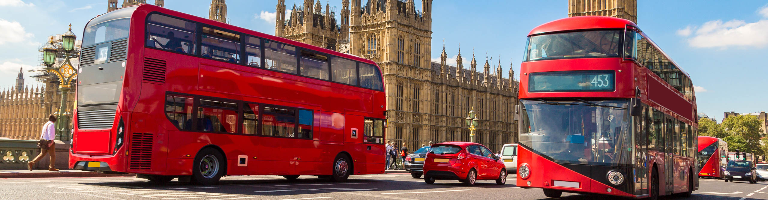  London buses.  driving past the House of Parliament, London, England on a sunny day