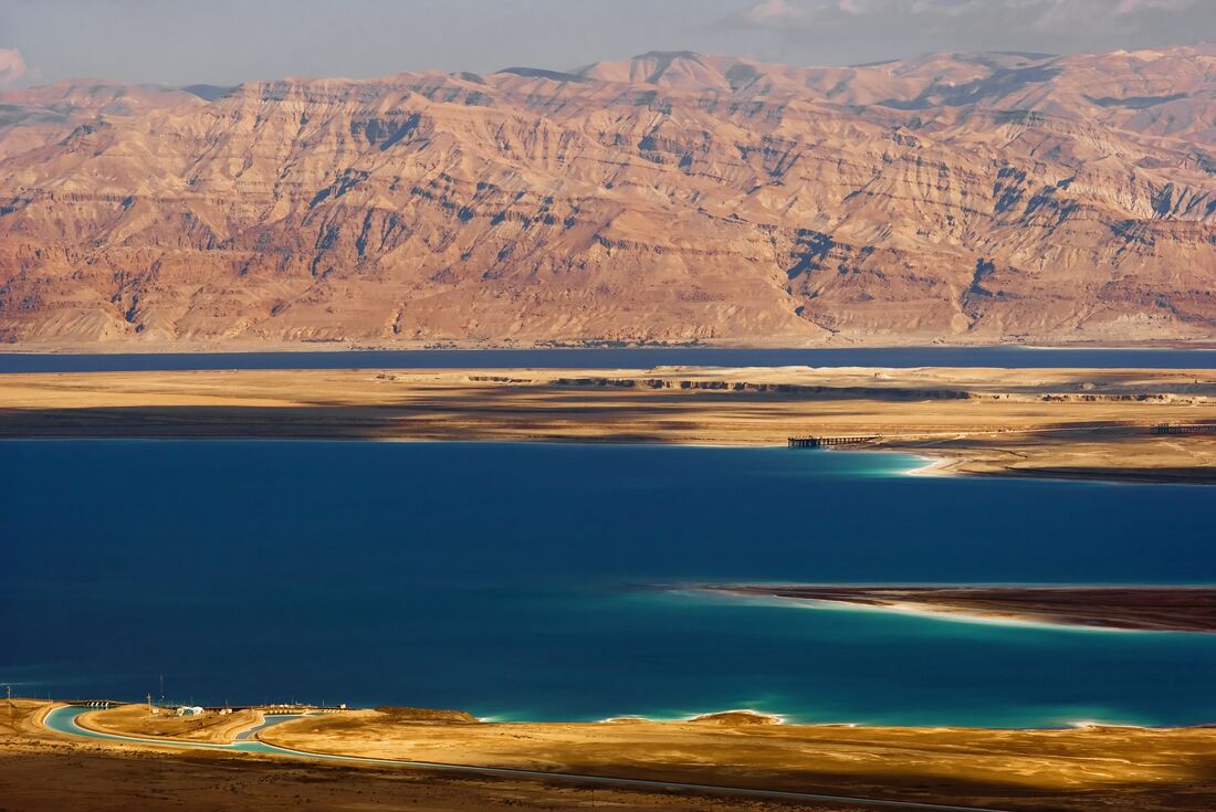 View of rocky mountains that surround the blue waters of the dead sea
