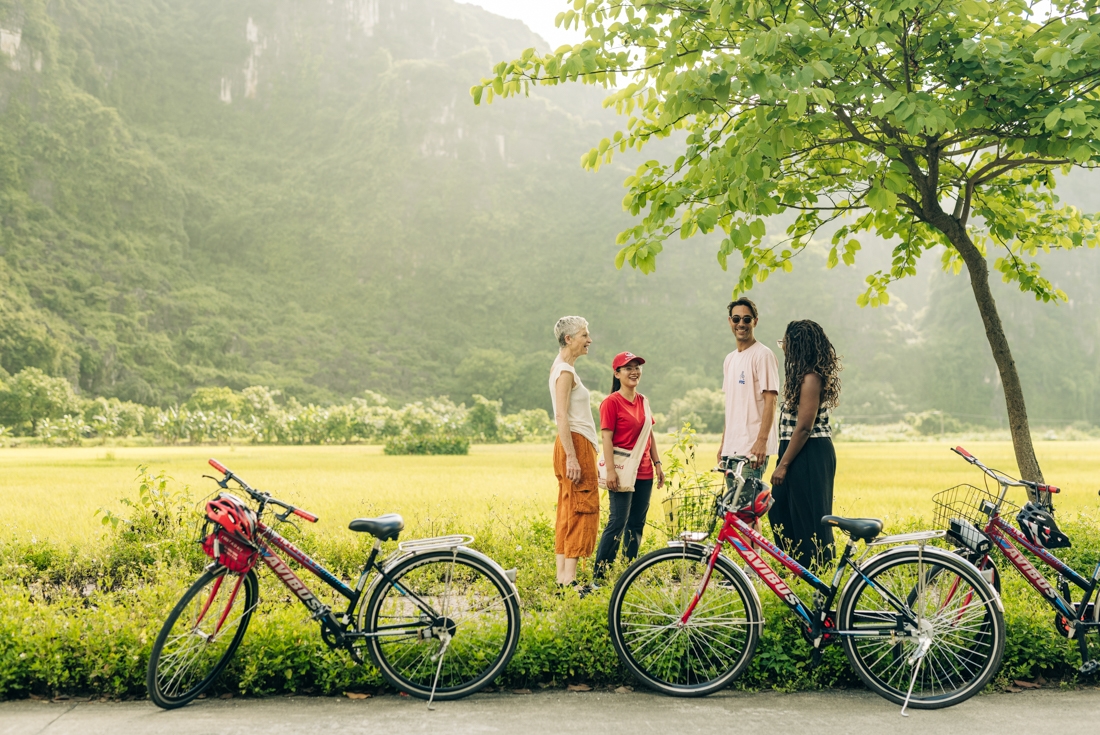 Intrepid travellers and leader stop cycling to bask in the Ninh Binh countryside