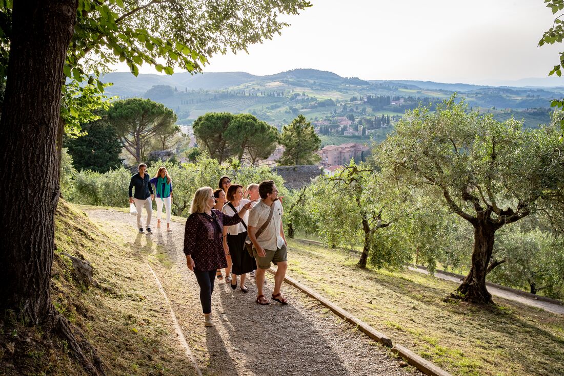 Travellers wander through the vineyards in San Gimignano