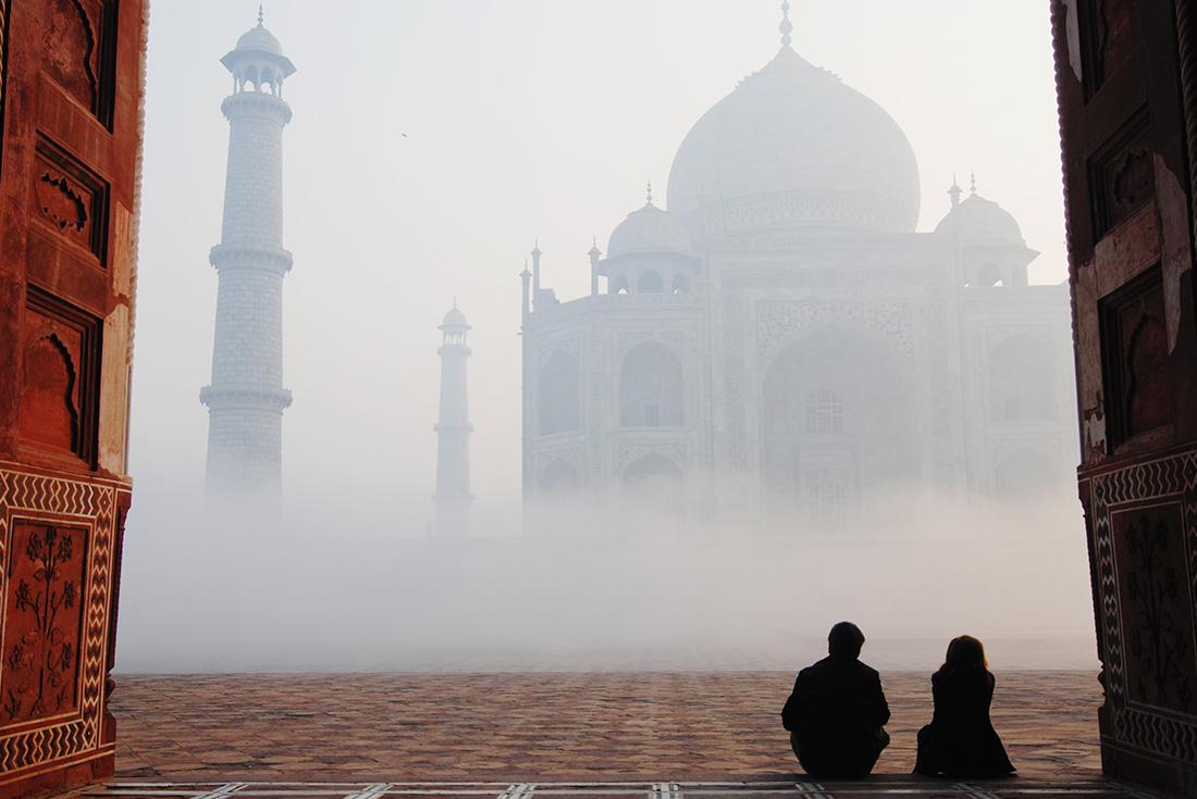 HHPG - Couple sitting in front of the Taj Mahal in the fog