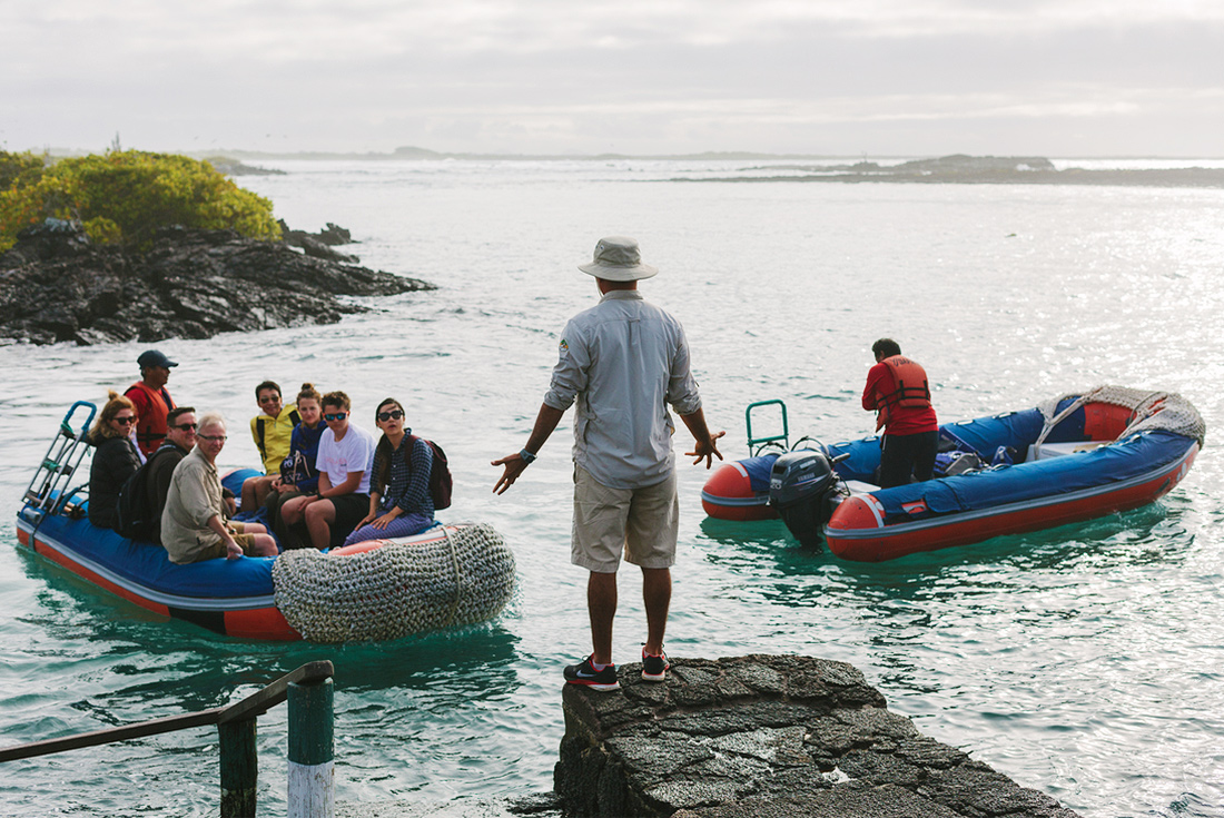 Group travellers and tour leader, panga boat rafts, Galapagos Islands