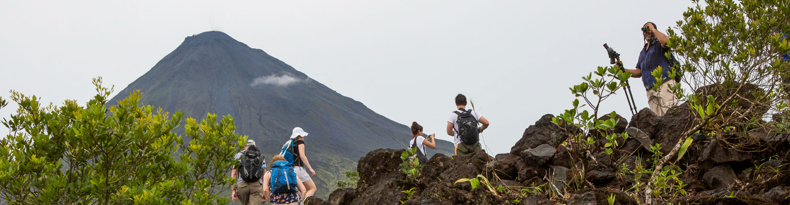 Photo of travelers hiking to Arenal Volcano