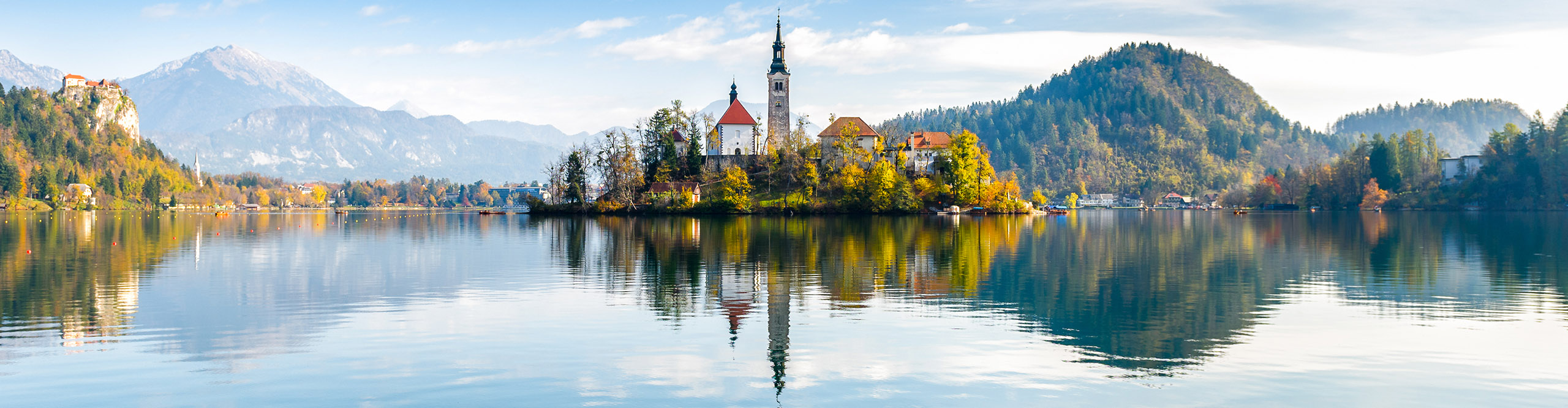 Lake Bled Slovenia, mountain lake with Assumption of Maria Pilgrimage church reflects in calm water.