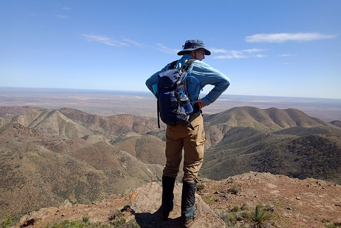 Hiker looking over the Flinders Ranges from lookout point, Australian Outback